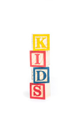KIDS with colorful alphabet blocks on white background