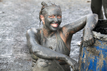 Portrait of woman covered in therapeutic mud, Dead Sea, Israel