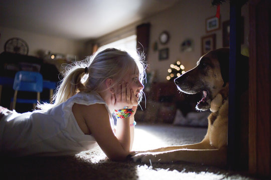 Girl and Dog Smiling at Each Other
