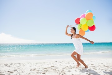  Beautiful woman holding balloon © WavebreakMediaMicro