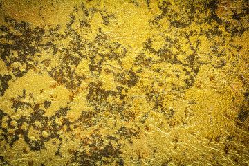 Abstract background texture of stone wall in yellow gold tone. Grunge wall. Cement wall texture and background with copy space for text or image. Dark edged.