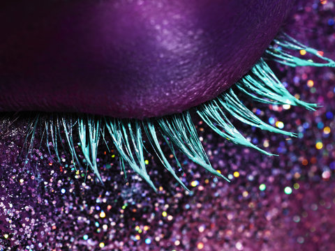 Close up of a woman's closed eye with iridescent makeup