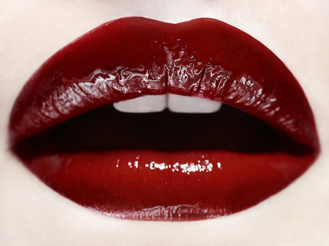 Close up of woman's mouth wearing red lipstick