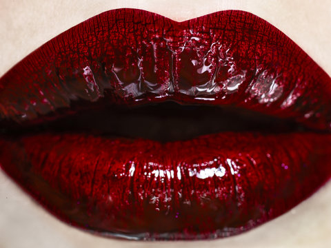 Close up of woman's mouth wearing red lipstick