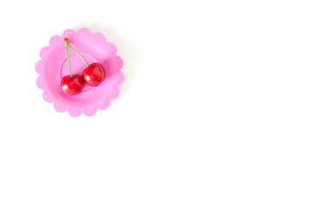 Obraz na płótnie Canvas Cherry on a bright saucer isolated white
