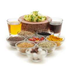 Raw ingredients for Indian mango pickle in glass bowls isolated on white background. 