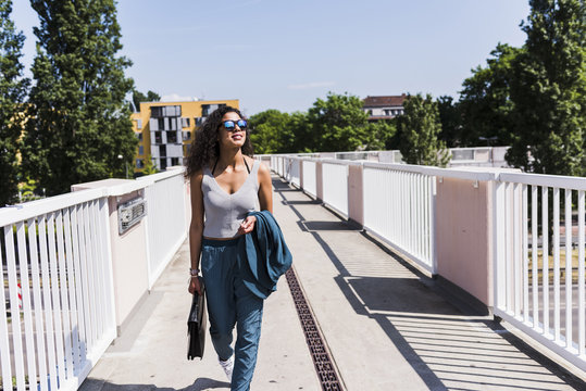 Young woman walking on bridge