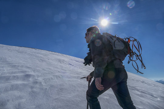 Italy, Umbria, Sibillini National Park, Hiker against the sun in winter