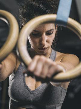Female athlete, hand on gymnastic ring