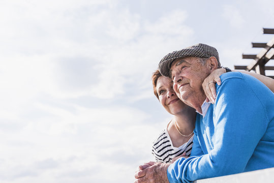 Senior man and his daughter looking together at distance