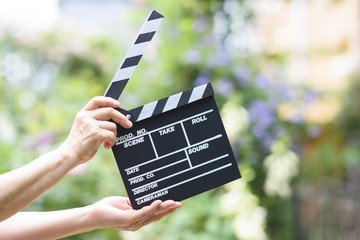 Hand with a clapperboard