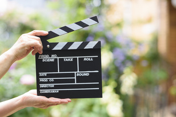 Hand with a clapperboard