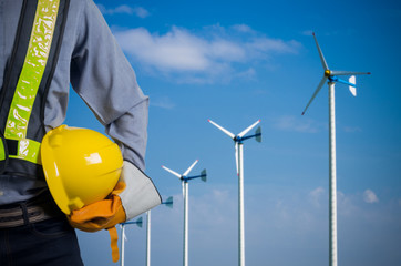 Engineer holding yellow helmet