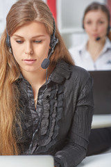 Female call center service operator at work. Portrait of pretty female helpdesk employee with...