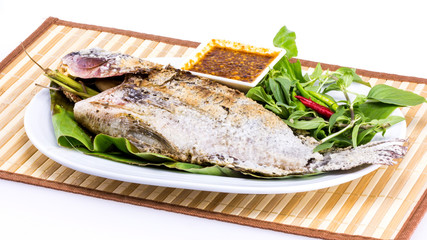 Grilled fish with salt on white plate