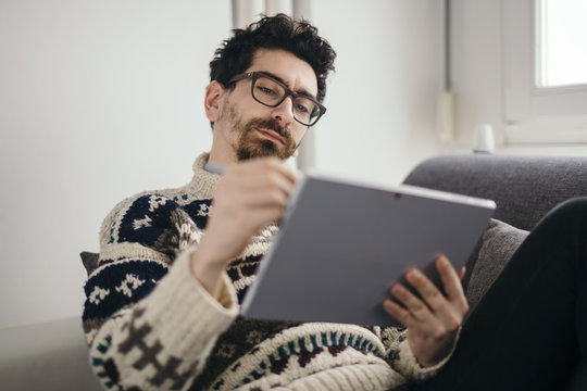 Portrait of man drawing something on digital tablet