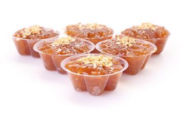 Front of group brown flavored sweet translucent gelatinous rice.