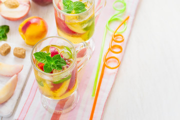 refreshing summer drink Peach Sweet Tea with ice and mint, Top v