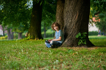 Boy with the tablet on a lap.