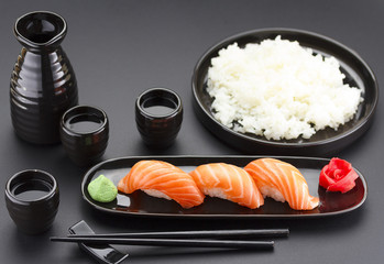 Japanese cuisine. Sushi roll with soy sauce over black background.