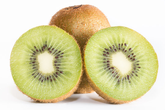 Cross section of ripe kiwi on white background