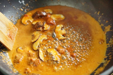 chilli paste boiled on non stick pan with bubble and vapore - soft focus select focus