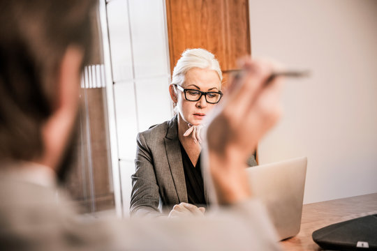 View over shoulder of businesswoman in meeting