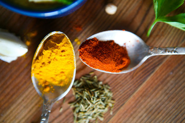 Healthy eating Background with herbs and spices selection on dark wooden table. Food or cooking concept, top view.