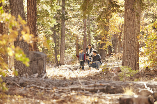 Father talking with his children in a forest