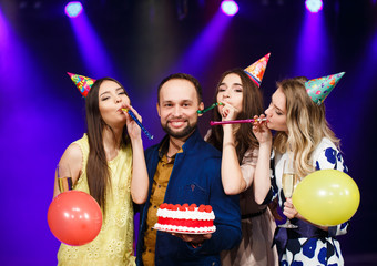 Happy birthday! Group of smiling friends gathered together with