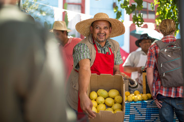 Market trader enticing shoppers to buy lemon