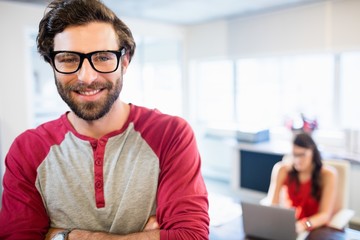 Smiling businessman with arms crossed