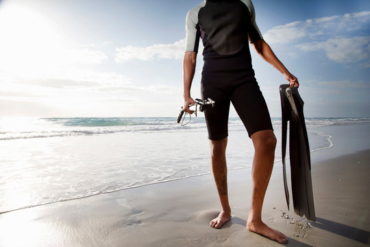 Diver with speargun on beach