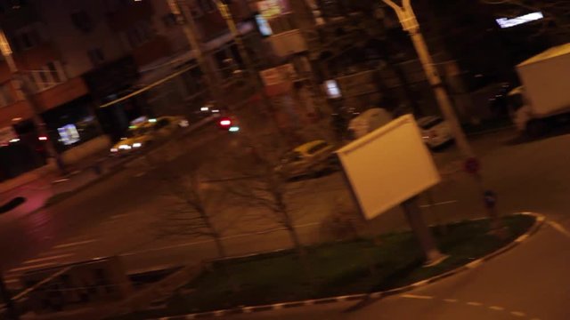 Aerial View Of A Street Late At Night, Dutch Angle, Pan, Rack Focus