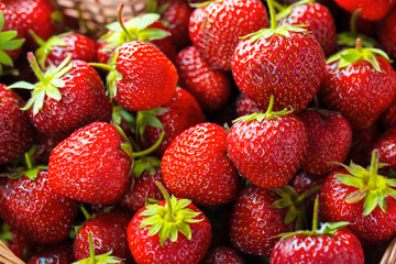 Very beautiful background with fresh strawberries in a wicker heart shaped wickerwork basket