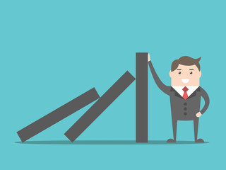 Obraz premium Businessman stopping domino effect