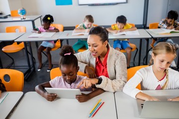 Teacher helping with tablet pc