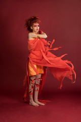 Phoenix woman. Flaming young girl on the red background