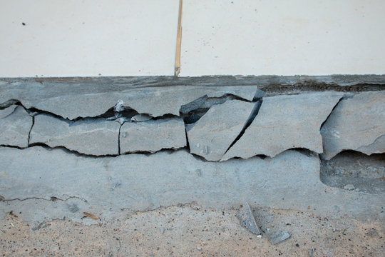 The area around the house collapsed, Paint peeling off the wall. Wall outdoor. Background wall