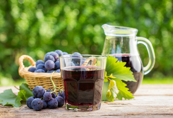 Grape juice in the glass and pitcher 