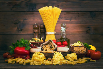 Variety of uncooked pasta and vegetables 