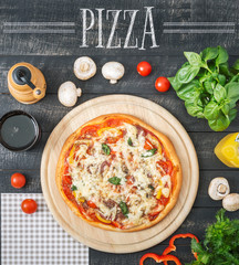 Traditional Italian Pizza on the Wooden background Top view