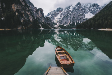 Boat on lake - Single boat waiting on calm, green waters of lake.