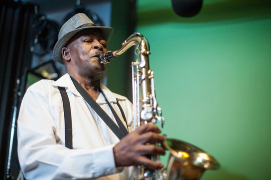 Male musician in recording studio, playing saxophone