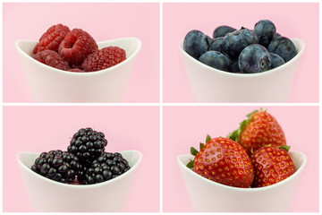 collection of berries in white ceramic bowls on pink  background isolated