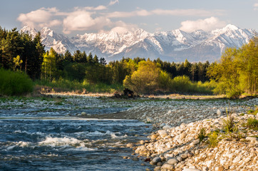 Beautiful spring panorama over Bialka river to snowy Tatra mountains, Poland