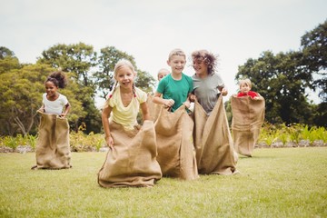 Children having a sack race - Powered by Adobe