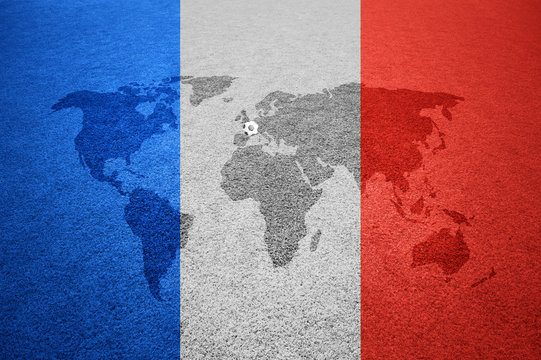 Soccer field with world map Europe caption and small soccer ball on France flag colored background.