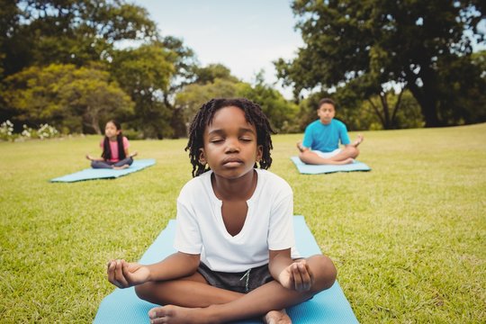 Portrait of children doing yoga with friends 