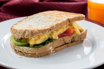 Food series : Egg sandwich whole wheat bread on white plate and orange juice